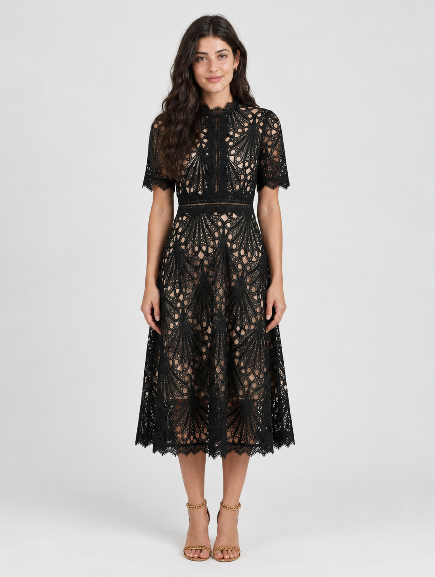 Woman wearing a black lace midi dress with high neckline and short sleeves, front view