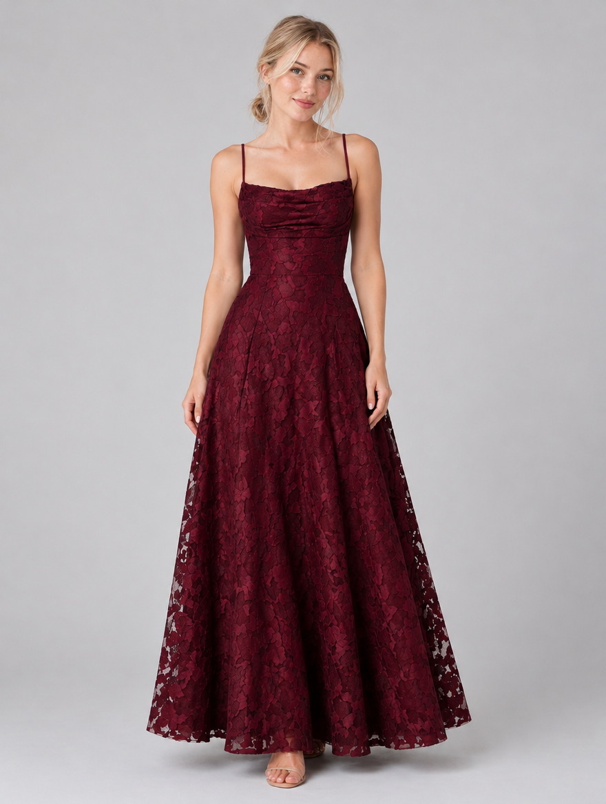 Woman wearing a burgundy lace maxi dress with spaghetti straps and cowl neckline, front view
