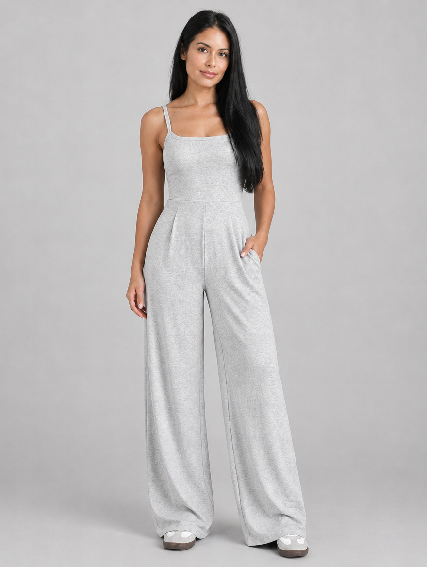 Woman wearing a light grey sleeveless wide-leg jumpsuit, front view