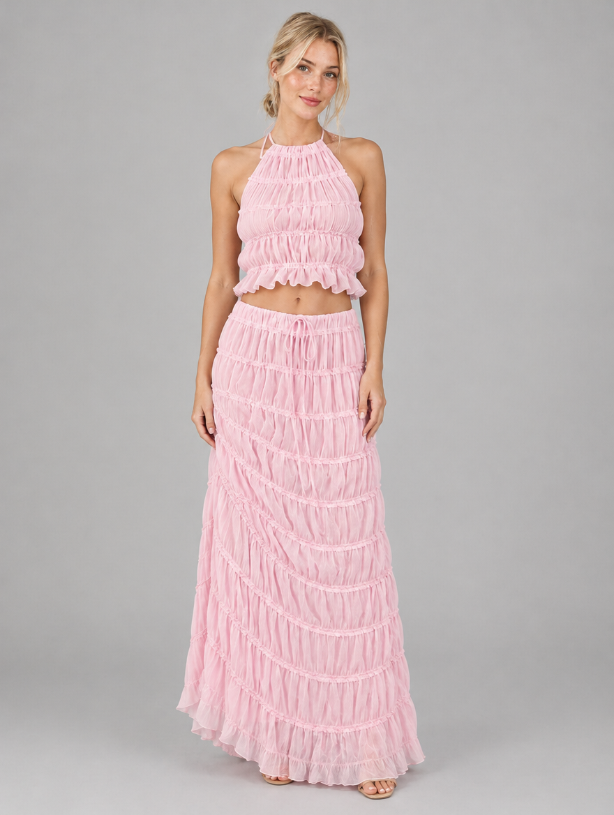 Woman wearing a pink ruched halter top and maxi skirt set, front view