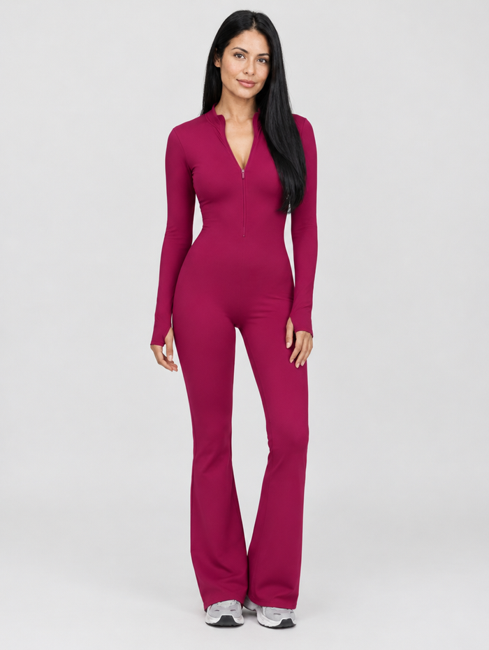 Woman wearing a burgundy zip front long sleeve flare jumpsuit, front view