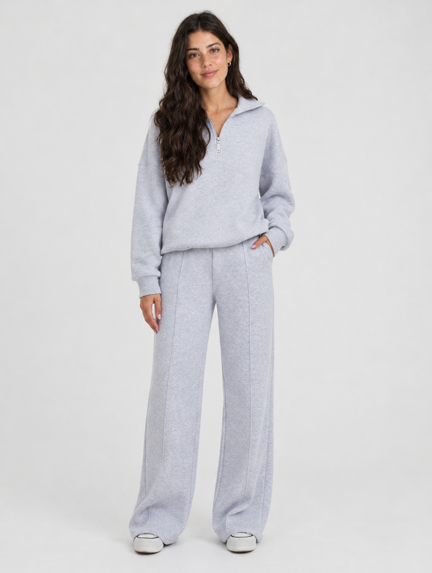 Woman wearing a light blue half zip pullover and wide leg pants lounge set, front view